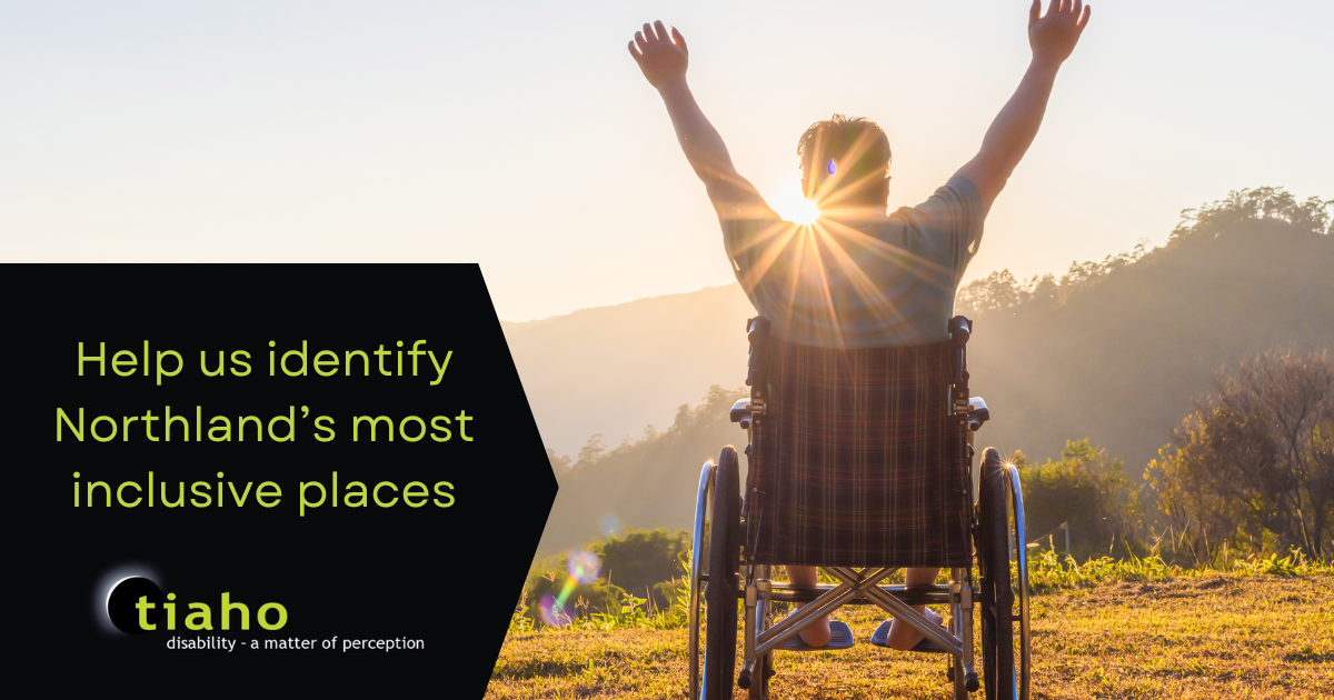 Man in a wheelchair on top of a hill looking out to the sunrise